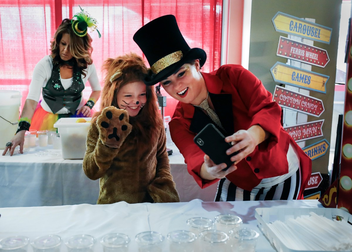 <strong>Dressed like a lion Noah Allen, 9, (left) takes a selfie with ringmaster Amber Lovell (right) as they hand out lemonade at the Youth Villages' fundraiser Sunday, Feb. 23, 2020 at the FedExForum.</strong> (Mark Weber/Daily Memphian)