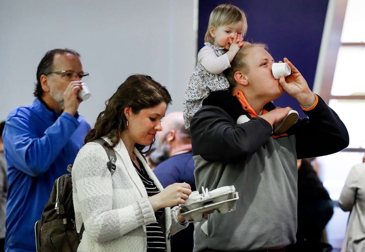 <strong>Cole Stonebrook samples soup while carrying his daughter 18-month-old daughter Liza during the 31st annual Youth Villages' Soup Sunday fundraiser&nbsp; Feb. 23, 2020 at the FedExForum.</strong> (Mark Weber/Daily Memphian)