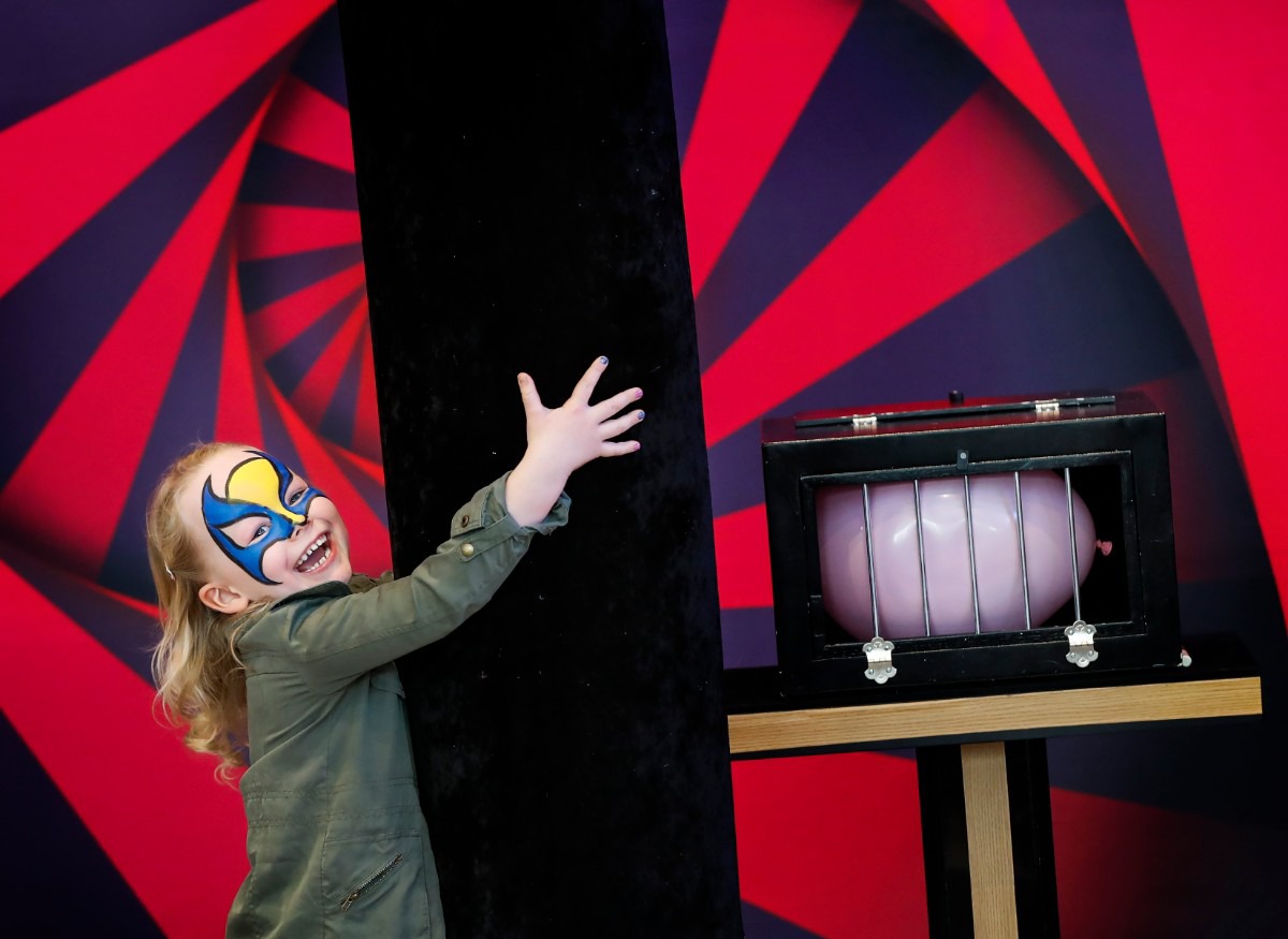 <strong>Harper Keller, 5, holds onto a oversized magic wand while taking part in a magic show during Villages' Soup Sunday fundraiser Feb. 23, 2020 at FedExForum.</strong> (Mark Weber/Daily Memphian)