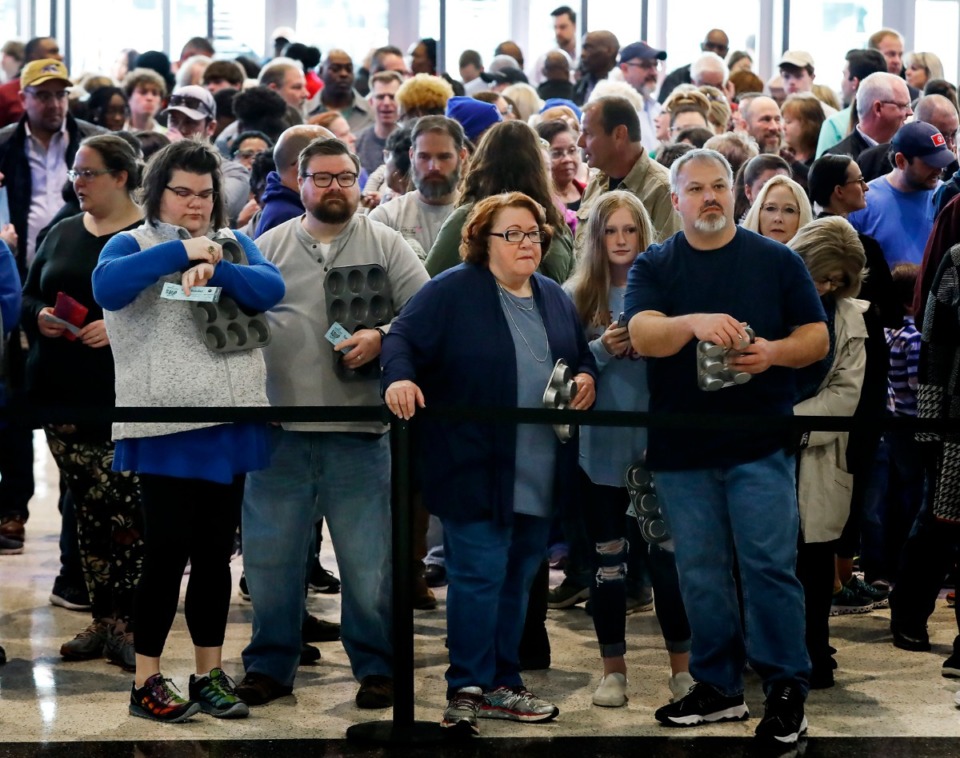 <strong>Hundreds of people holding cupcake pans (to carry their samples) wait for the 31st annual Youth Villages' Soup Sunday fundraiser to open on Sunday, Feb. 23, 2020 at FedExForum.</strong> (Mark Weber/Daily Memphian)