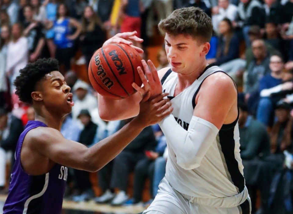 <strong>Houston forward Zander Yates (right) drives the lane against Southwind defender Torien Stewart (left) during action on Tuesday, Feb. 25, 2020 in Germantown.</strong> (Mark Weber/Daily Memphian)
