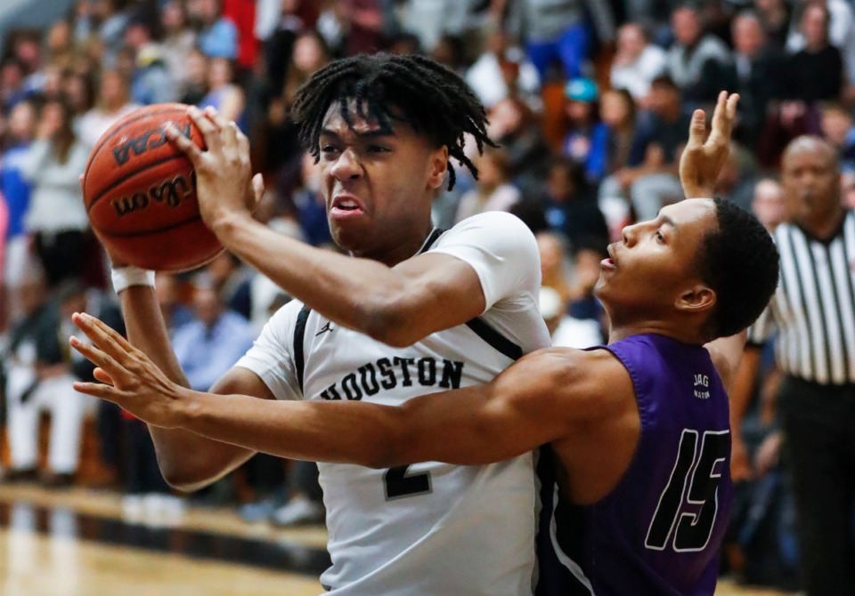 <strong>Houston forward Alden Applewhite (left) drives the lane against Southwind defender Sir Alexander (right) during action on Tuesday, Feb. 25, 2020 in Germantown.</strong> (Mark Weber/Daily Memphian)