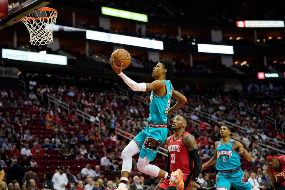 <strong>Memphis Grizzlies' Ja Morant (12) goes up for a shot as Houston Rockets' Robert Covington (33) watches during the second half of an NBA basketball game Wednesday, Feb. 26, 2020, in Houston. The Rockets won 140-112.</strong> (AP Photo/David J. Phillip)