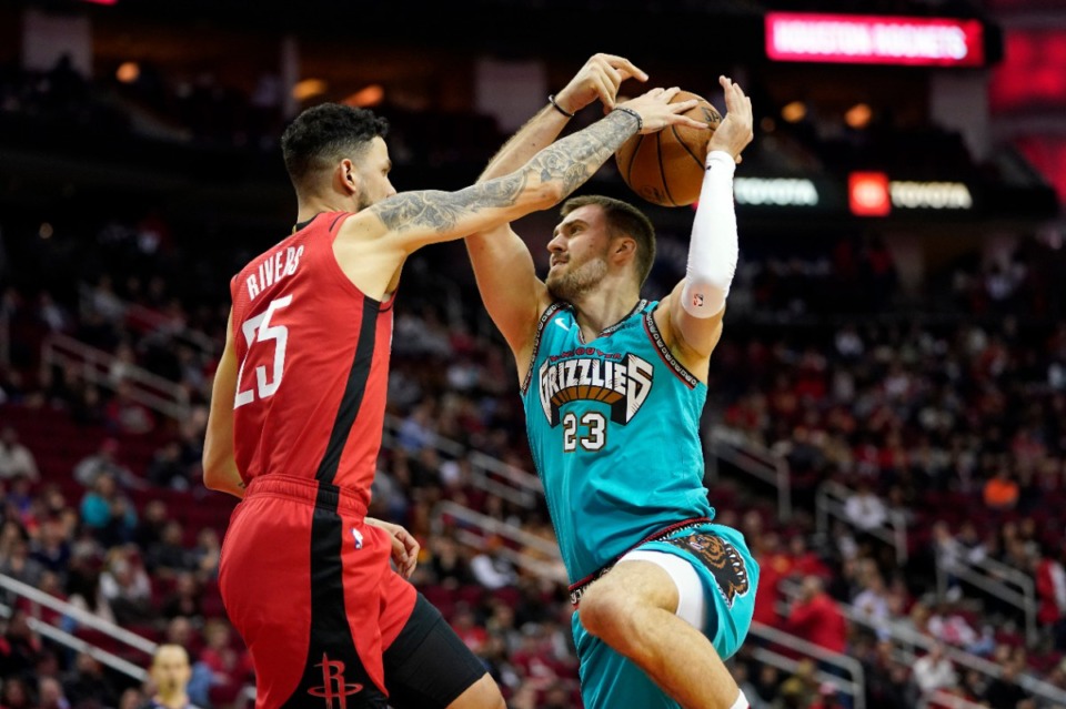 <strong>Memphis Grizzlies' Marko Guduric (23) is fouled by Houston Rockets' Austin Rivers (25) during the second half of an NBA basketball game Wednesday, Feb. 26, 2020, in Houston. The Rockets won 140-112.</strong> (AP Photo/David J. Phillip)