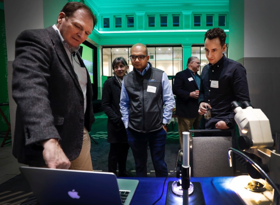 <strong>Lepidext Vice President Bruce Webb (left) discusses corn earworm pest control with Suhas Narayanaswamy (middle) and Alex Behar (right) before present during AgLaunch Demo Day Thursday, Feb. 27, 2020, at Central Station.</strong> (Mark Weber/Daily Memphian)