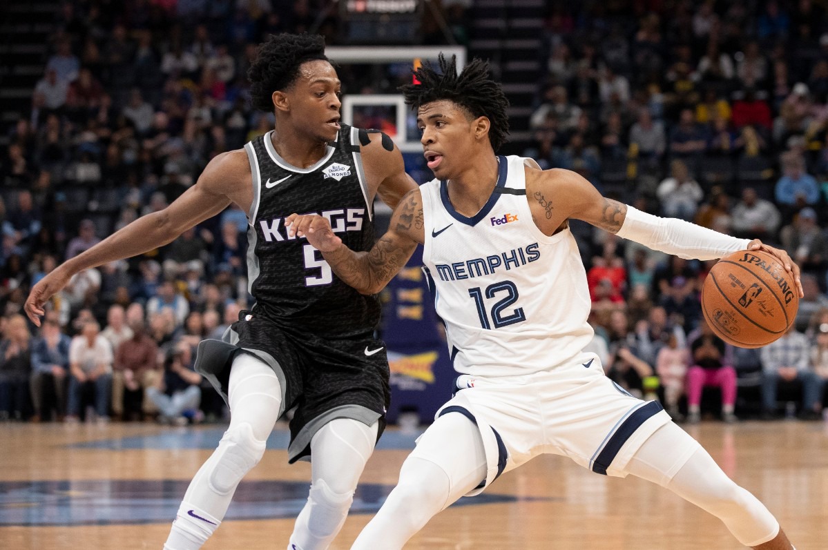 <strong>Memphis Grizzlies guard Ja Morant (12) is defended by Sacramento Kings guard De'Aaron Fox (5) Friday, Feb. 28, 2020, at FedExForum.</strong> (Nikki Boertman/AP)