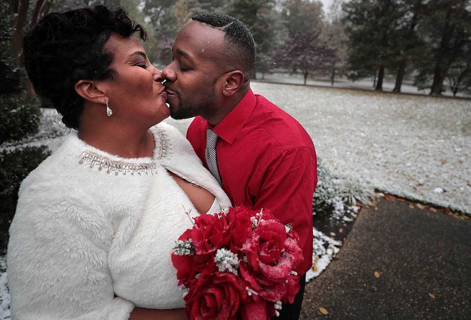 <strong>Tamika Kerr and her new husband, Greg Kerr, cuddle in the cold at Overton Park in Midtown Memphis after tying the knot in a surprise snowy wedding on Nov. 14, 2018.&nbsp;&nbsp;</strong>(Jim Weber/Daily Memphian)