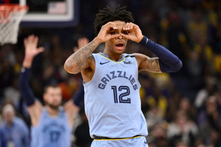 <strong>Memphis Grizzlies guard Ja Morant (12) reacts after an assist to center Jonas Valanciunas (17) in the second half of an NBA basketball game against the Los Angeles Lakers, Saturday, Feb. 29, 2020, in Memphis.</strong> (AP Photo/Brandon Dill)