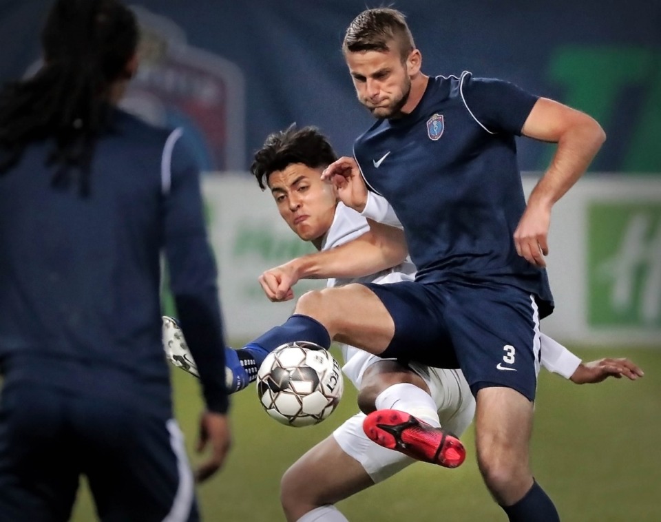 <strong>Memphis 901 FC defender Zach Carroll (3) battles for control of the ball against the Tigers' Jovan Prado (20) during 901 FC's preseason exhibition game against the University of Memphis at AutoZone Park on Feb. 29, 2020.</strong> (Jim Weber/Daily Memphian)