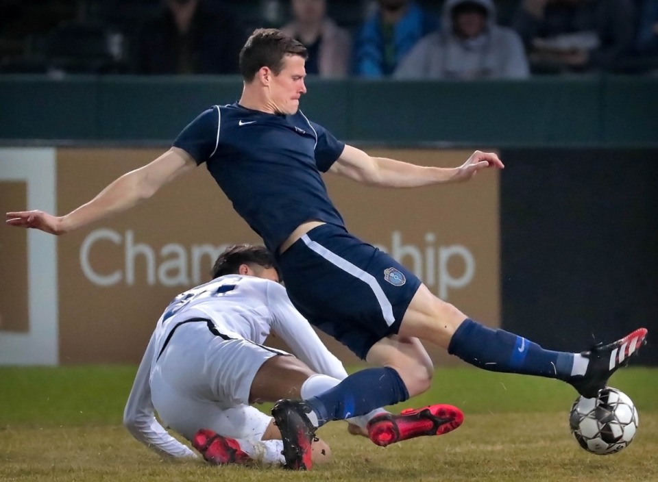 <strong>Memphis'&nbsp;<span>Michael Reed (17)&nbsp;</span>is tripped up by the Tigers&nbsp;<span>Jovan Prado (20)&nbsp;</span>during 901FC's preseason exhibition games against the University of Memphis at Autozone Park on Feb. 29, 2020.</strong> (Jim Weber/Daily Memphian)