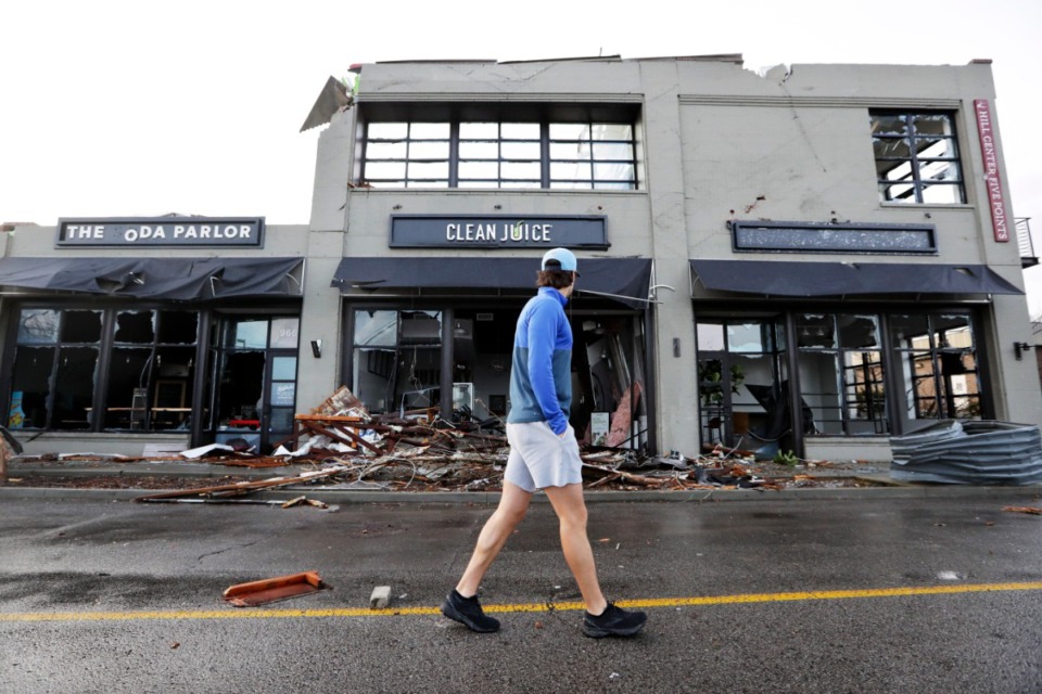 <strong>A man walks by buildings destroyed by storms Tuesday, March 3, 2020, in Nashville, Tennessee. Tornadoes ripped across Tennessee early Tuesday, shredding buildings and killing multiple people.</strong> (AP Photo/Mark Humphrey)