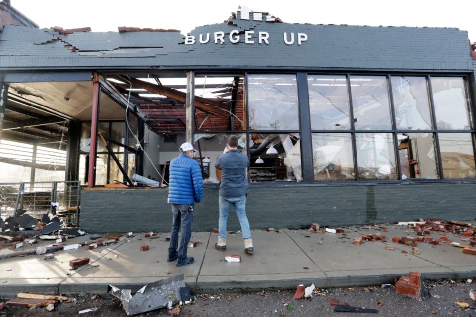 <strong>People look over a restaurant destroyed by storms Tuesday, March 3, 2020, in Nashville, Tennessee. Tornadoes ripped across Tennessee early Tuesday, shredding buildings and killing multiple people.</strong> (AP Photo/Mark Humphrey)