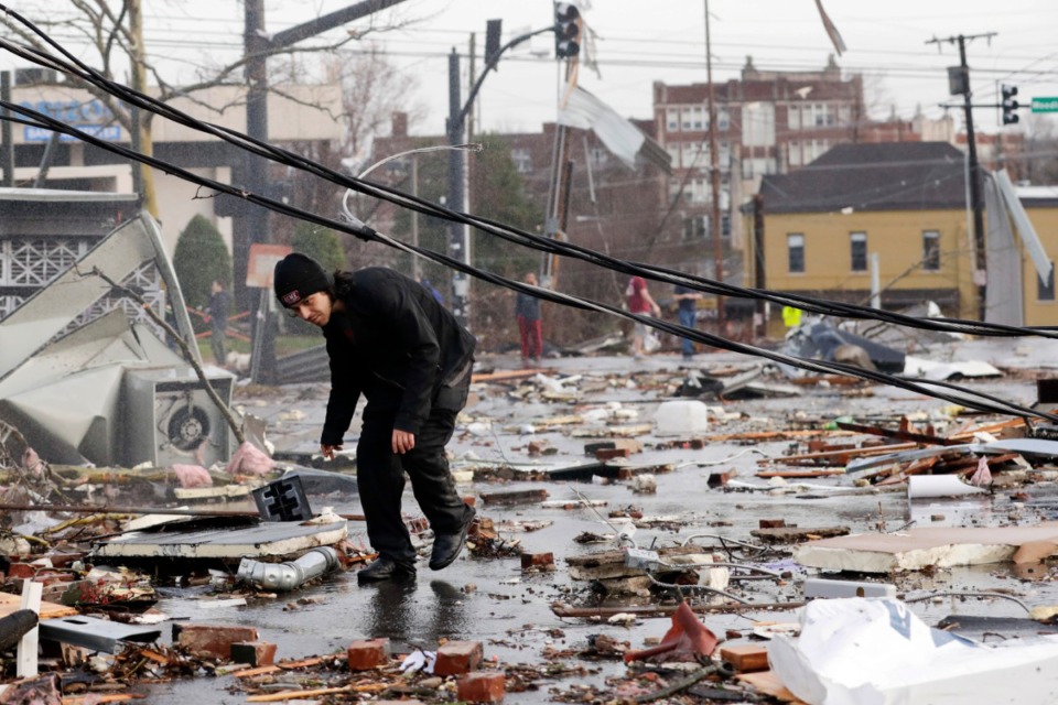 <strong>A man walks through storm debris following a deadly tornado Tuesday, March 3, 2020, in Nashville, Tennessee. Tornadoes ripped across Tennessee early Tuesday, shredding buildings and killing multiple people.</strong> (AP Photo/Mark Humphrey)