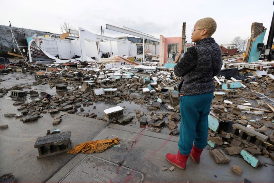 <strong>Faith Patton looks over buildings destroyed by storms Tuesday, March 3, 2020, in Nashville, Tennessee. Tornadoes ripped across Tennessee early Tuesday, shredding buildings and killing multiple people. Patton lives near the damaged area but her home was intact.</strong> (AP Photo/Mark Humphrey)
