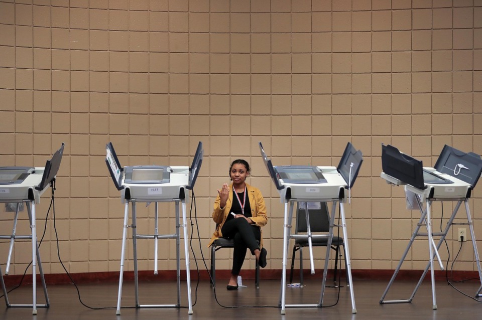 <strong>Poll worker Shelby Wordlaw gestures to voters to approach the machines at the Great Hall polling location in Germantown as voters turned out on March 3, 2020, to vote in the Super Tuesday primaries.</strong> (Jim Weber/Daily Memphian)&nbsp;
