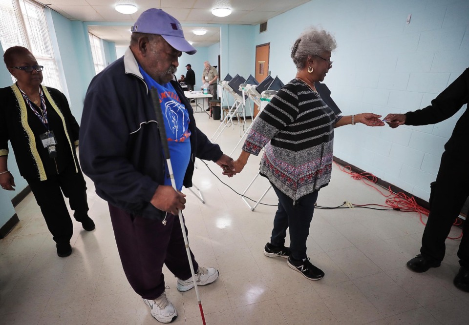 <strong>Corinther Payne helps her husband, Jesse Payne, who is blind, navigate the voting machines after voting at the Bellevue Frayser Church polling location as voters turn out on March 3, 2020, to vote in the Super Tuesday primaries.</strong> (Jim Weber/Daily Memphian)&nbsp;