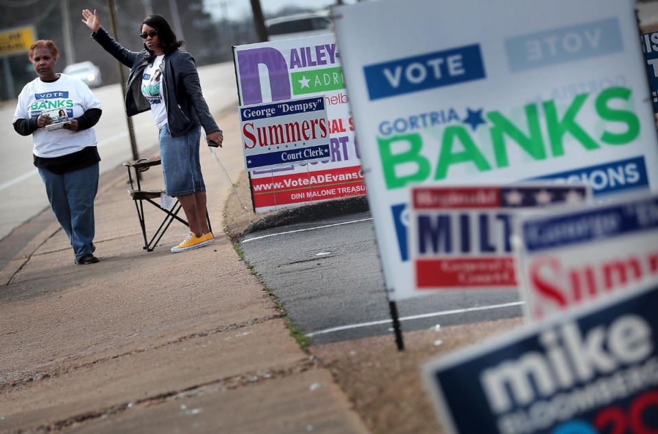 <strong>Volunteer Teresa Sims (left) and General Sessions Court Clerk candidate Gortria Banks wave at passing cars at the Bellevue Frayser Church polling location as voters turn out on March 3, 2020, to vote in the Super Tuesday primaries.</strong> (Jim Weber/Daily Memphian)&nbsp;