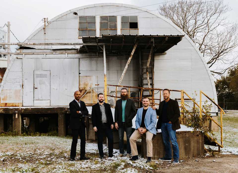 <strong>Jeff White (from left), Mark Patrick, Tyler Nelson, William "Hopper" Seely and his father, Bill Seely, stand in front of the soon-to-be Grind City Brewery. Hopper Seely grew up brewing beer with his father and after graduating from Brewlab in Sunderland, England, he decided to open his own brewery in Memphis.</strong> (Houston Cofield/Daily Memphian)