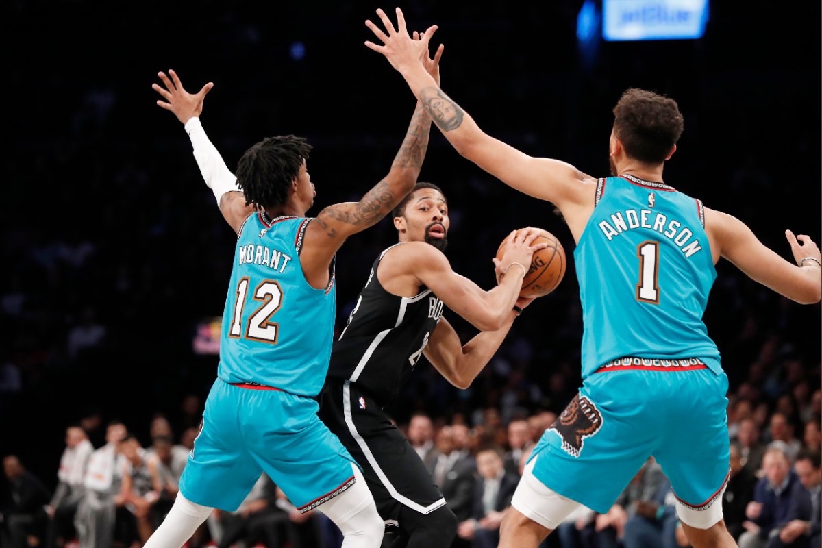 <strong>Brooklyn Nets guard Spencer Dinwiddie, center, looks to pass with Memphis Grizzlies guard Ja Morant (12) and Grizzlies forward Kyle Anderson (1) defending him during the second quarter of an NBA basketball game Wednesday, March 4, 2020, in New York.</strong> (Kathy Willens/AP)