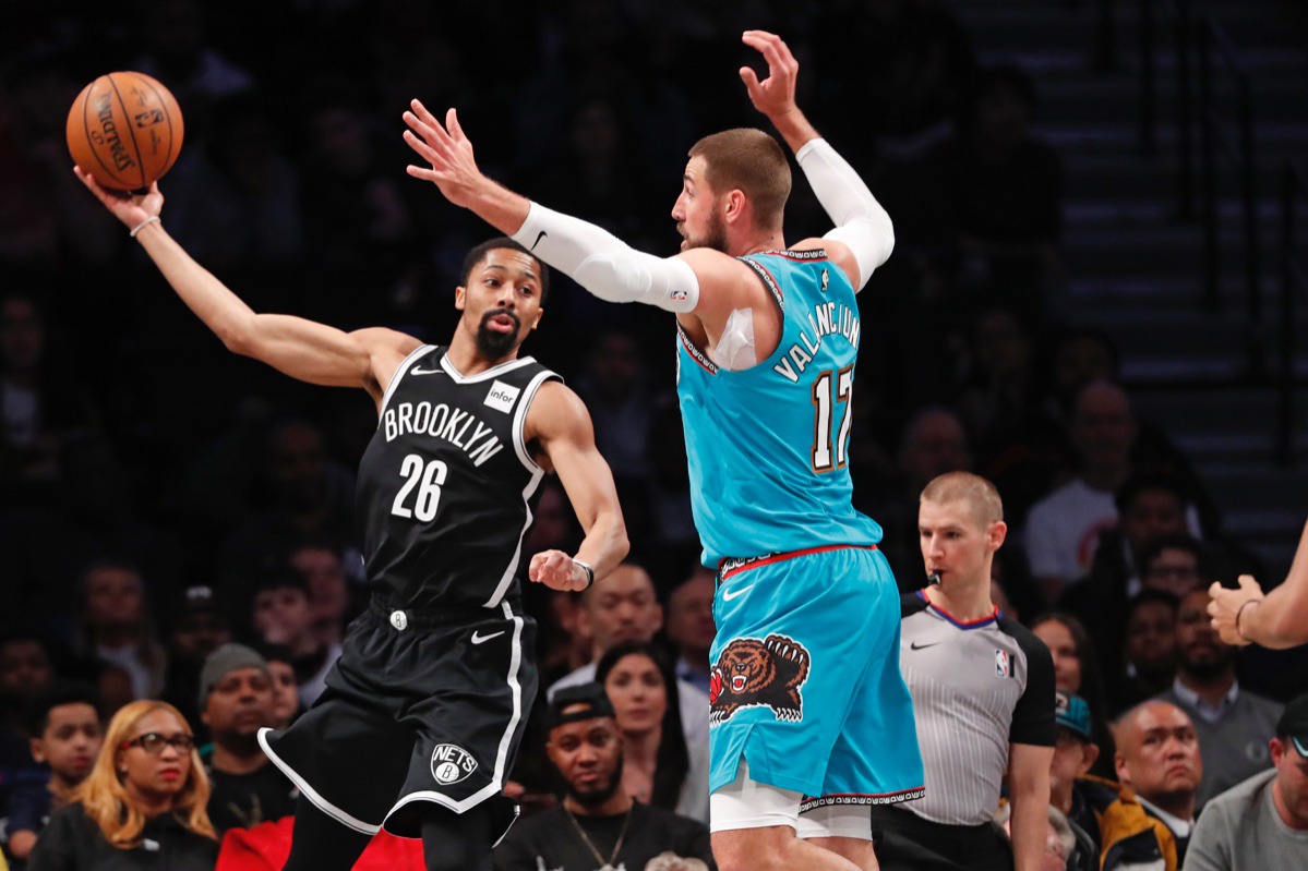 <strong>Brooklyn Nets guard Spencer Dinwiddie (26) passes around Memphis Grizzlies center Jonas Valanciunas (17) March 4, 2020, in New York.</strong> (Kathy Willens/AP)