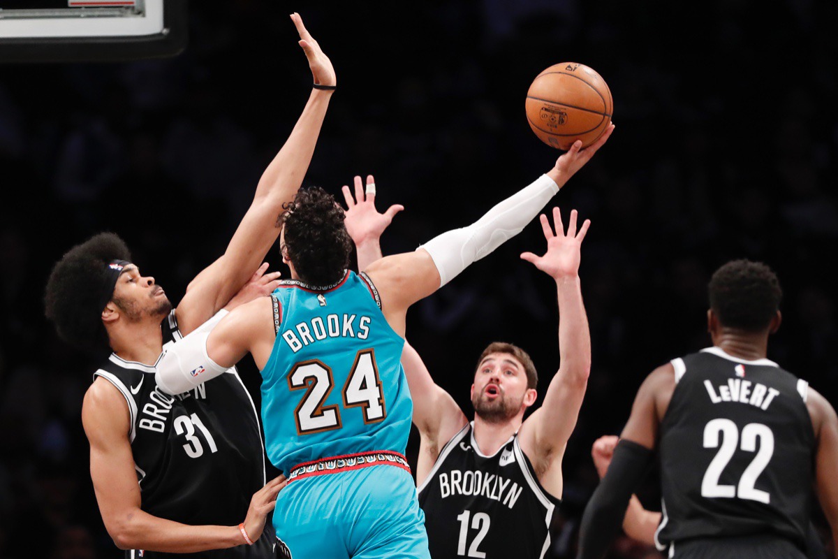 <strong>Brooklyn Nets center Jarrett Allen (31) and Nets forward Joe Harris (12) defend against a shot by Memphis Grizzlies guard Dillon Brooks (24) March 4, 2020, in New York. Brooklyn Nets guard Caris LeVert (22) watches, lower right.</strong> (Kathy Willens/AP)