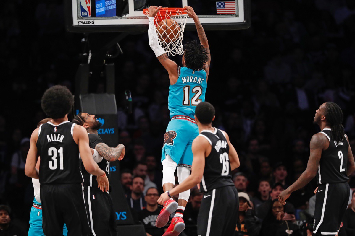 <strong>Memphis Grizzlies guard Ja Morant (12) dunks as Brooklyn Nets center Jarrett Allen (31), Nets guard Spencer Dinwiddie (26) and Brooklyn Nets forward Taurean Prince (2) are left flat-footed March 4, 2020, in New York.</strong> (Kathy Willens/AP)