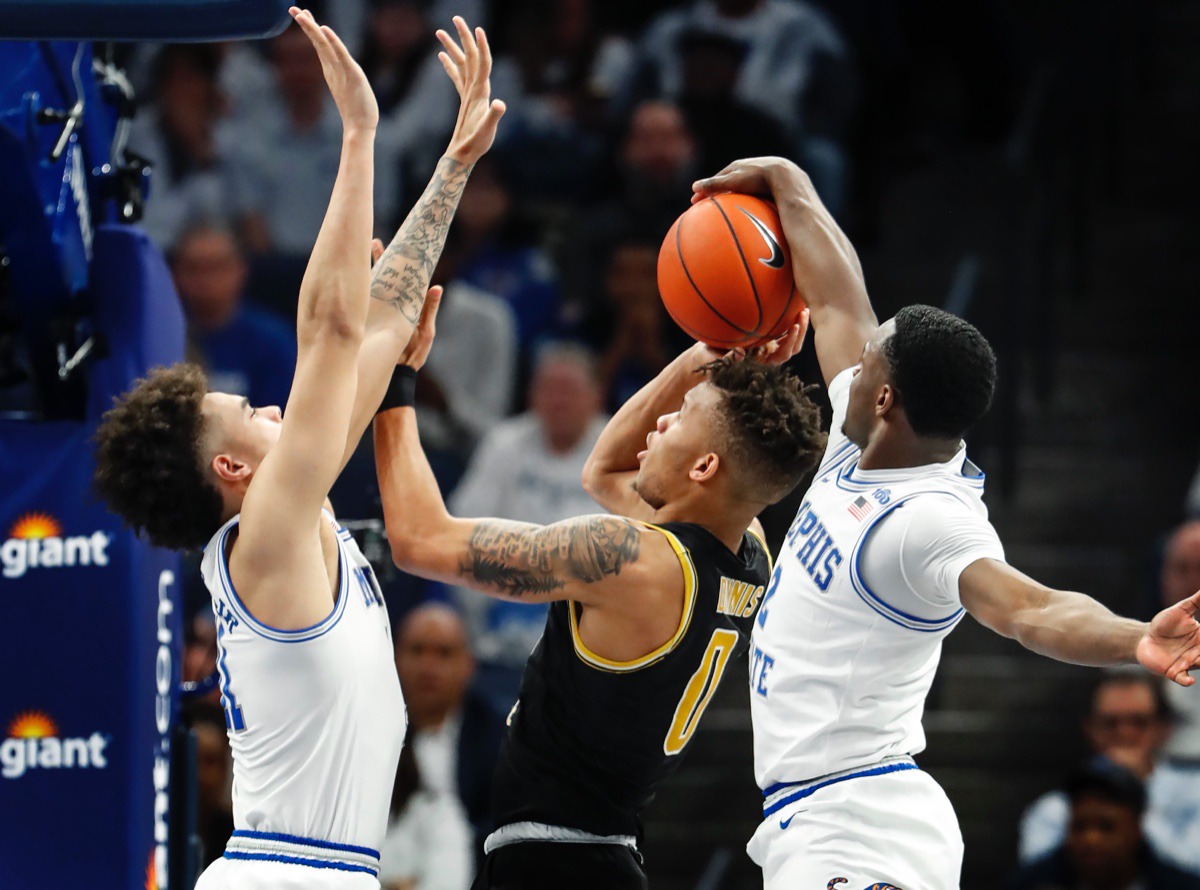 <strong>Alex Lomax (right) blocks Wichita State guard Dexter Dennis (middle) as teammate Lester Quinones (left) helps March 5, 2020, at FedExForum.</strong> (Mark Weber/Daily Memphian)