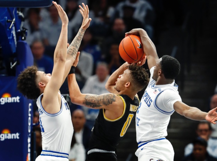 <strong>Alex Lomax (right) blocks Wichita State guard Dexter Dennis (middle) as teammate Lester Quinones (left) assists March 5, 2020, at FedExForum.</strong> (Mark Weber/Daily Memphian)