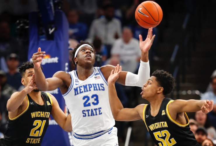 <strong>Memphis center Malcolm Dandridge (middle) grabs a loose ball from Wichita State's Jaime Echenique (left) and Grant Sherfield (right) March 5, 2020, at FedExForum.</strong> (Mark Weber/Daily Memphian)
