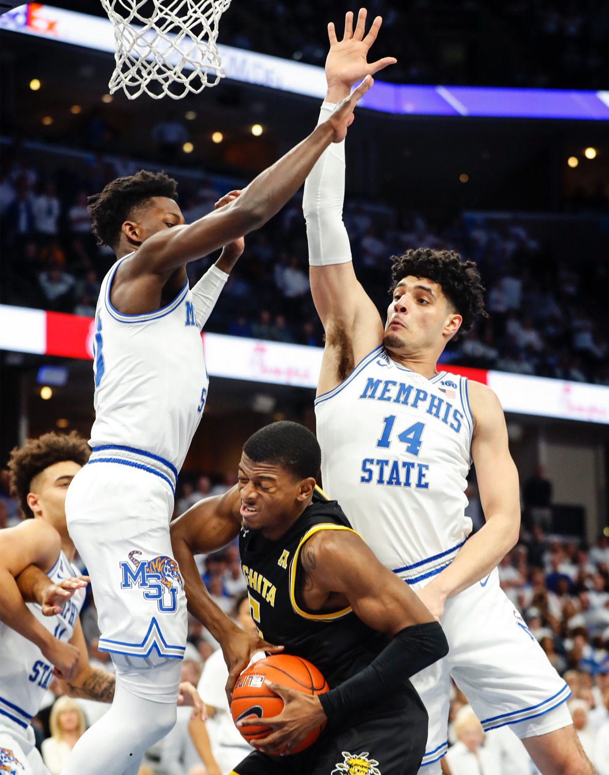 <strong>Memphis defenders Damion Baugh (left) and Isaiah Maurice (right) apply pressure to Wichita State guard Trey Wade (middle) March 5, 2020, at FedExForum.</strong> (Mark Weber/Daily Memphian)