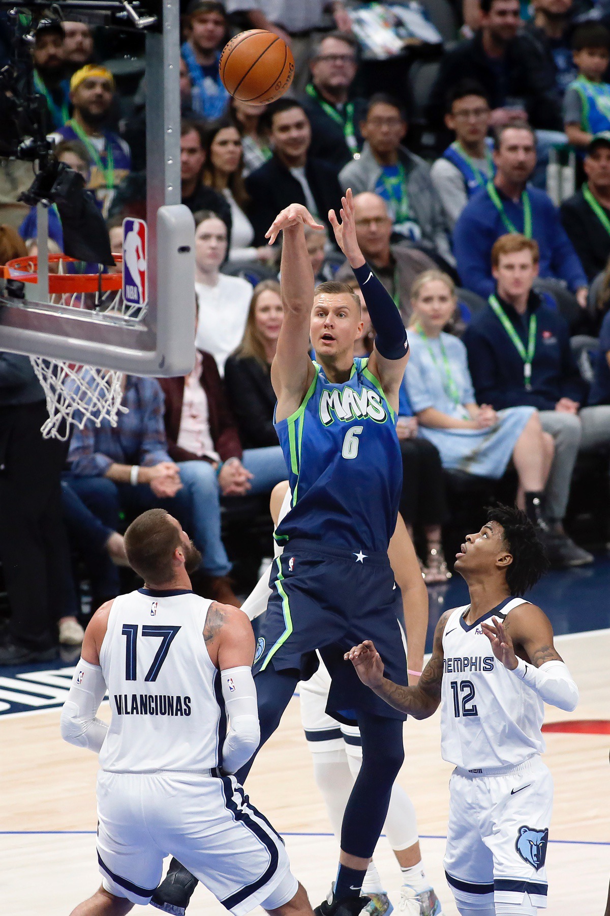 <strong>Dallas Mavericks forward Kristaps Porzingis (6) shoots the three-point basket over Memphis Grizzlies center Jonas Valanciunas (17) and guard Ja Morant (12) during the first half of an NBA basketball game in Dallas, Friday, March 6, 2020.</strong> (AP Photo/Ray Carlin)