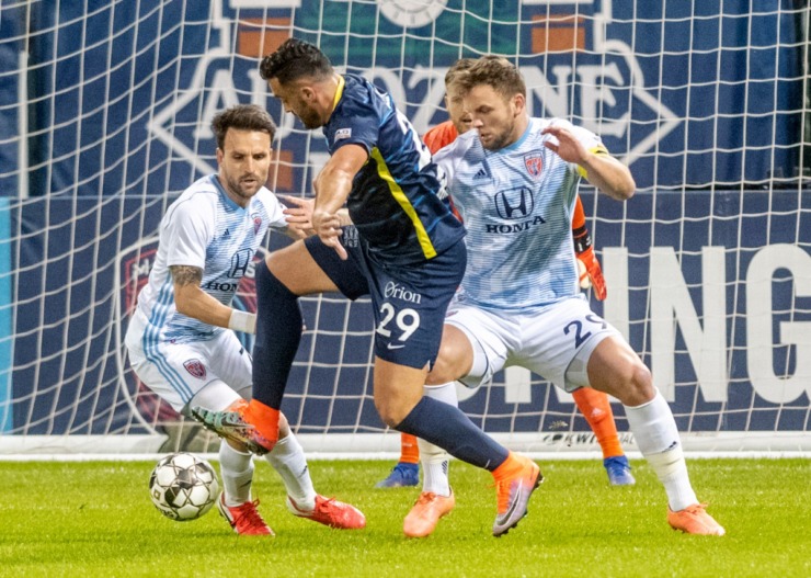 <strong>Memphis 901 FC forward Brandon Allen scores an early goal against Indy Eleven defenders Ayoze Garcia and Paddy Barrett at AutoZone Park Saturday, March 7, 2020. Despite the early lead, Memphis lost 4-2 in their season-opening match.</strong> (Greg Campbell/Special to The Daily Memphian)