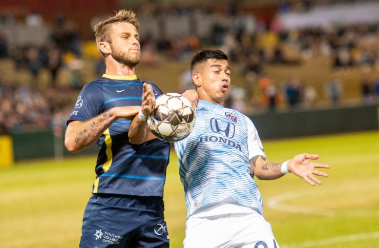 <strong>Memphis 901 FC defender Zach Carroll goes for the ball against Indy Eleven forward Yeferson Contreras during Saturday's season opener at AutoZone Park.</strong> (Greg Campbell/Special to The Daily Memphian)