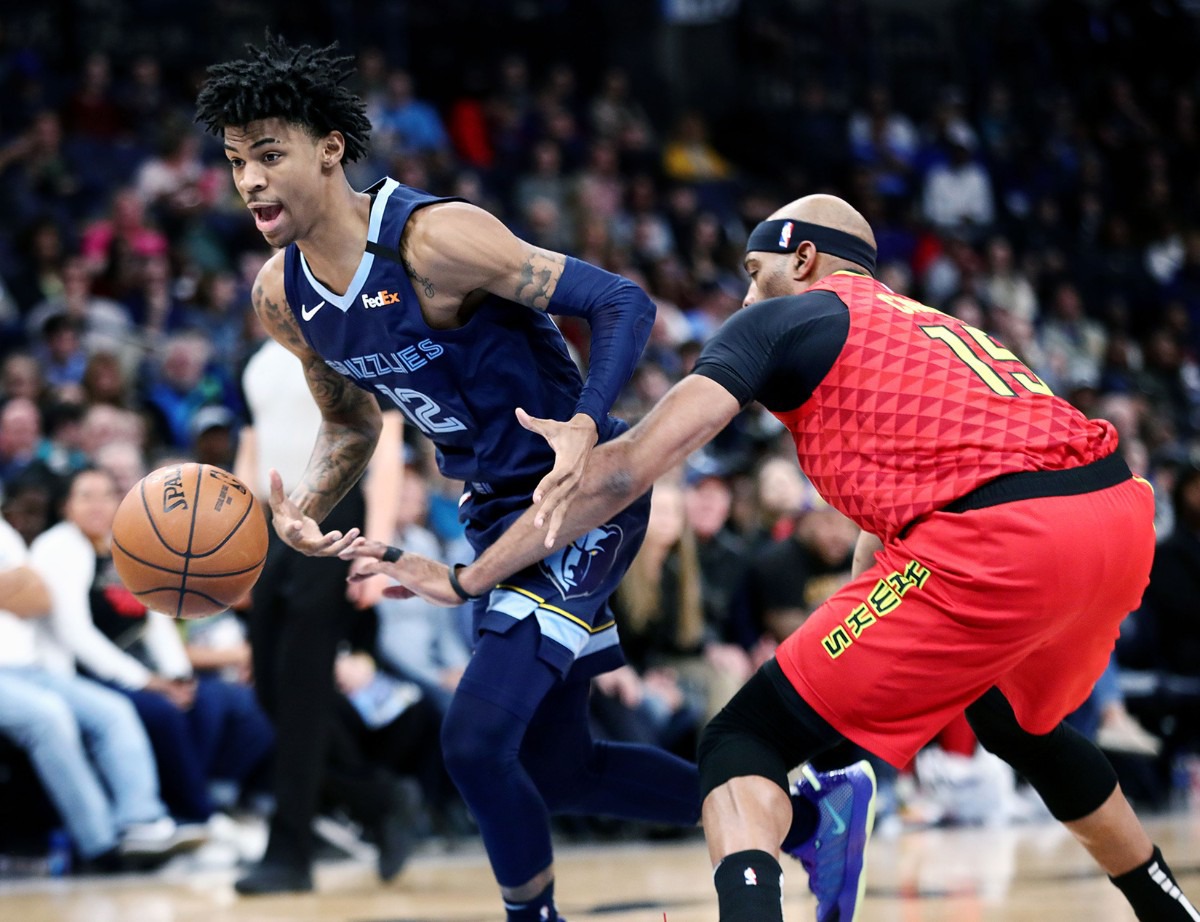 <strong>Memphis Grizzlies guard Ja Morant (12) is fouled by Vince Carter (15) during a March 7, 2020, game at FedExForum against the Atlanta Hawks.</strong> (Patrick Lantrip/Daily Memphian)