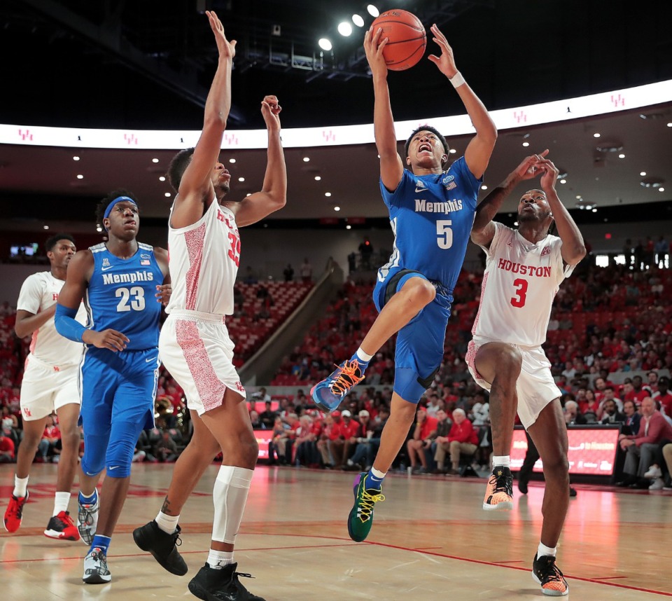 <strong>University of Memphis guard Boogie Ellis shoots under pressure by Houston's DeJon Jarreau (3) and Fabian White (35) during the Tigers' game against the Cougars at the Fertitta Center in Houston on March 8, 2020.</strong> (Jim Weber/Daily Memphian)