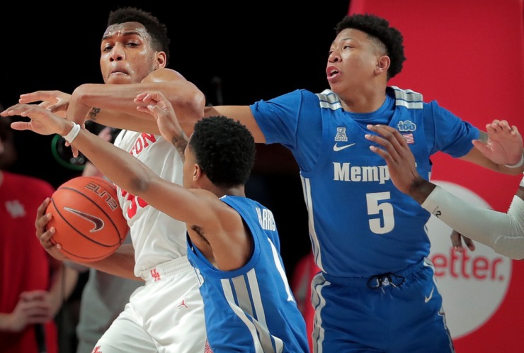 <strong>Houston Forward Fabian White (left) fends off University of Memphis guard Boogie Ellis (5) and Tyler Harris after a rebound during the Tigers' game against the Cougars at the Fertitta Center in Houston on March 8, 2020.</strong> (Jim Weber/Daily Memphian)