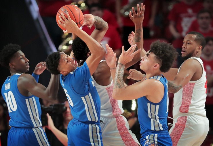 <strong>University of Memphis guards Damion Baugh (10) Boogie Ellis (5) and Lester Quinones battle for control of a rebound during the Tigers' game against the Cougars at the Fertitta Center in Houston on March 8, 2020.</strong> (Jim Weber/Daily Memphian)