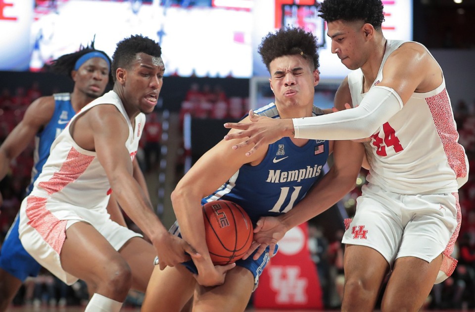 <strong>University of Memphis guard Lester Quinones (11) is fouled on a drive by Houston's Quentin Grimes (right) during the Tigers' game against the Cougars at the Fertitta Center in Houston on March 8, 2020.</strong> (Jim Weber/Daily Memphian)