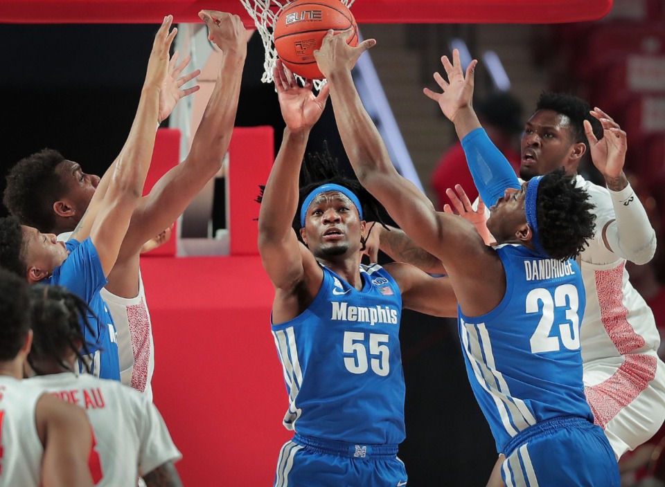 <strong>University of Memphis forward Precious Achiuwa (55) and forward Malcolm Dandridge (23) stretch for a rebound under pressure by Houston's Chris Harris Jr. (right) and Fabian White (left) during the Tigers' game against the Cougars at the Fertitta Center in Houston on March 8, 2020.</strong> (Jim Weber/Daily Memphian)