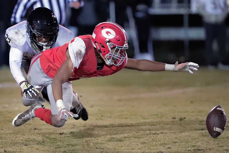 <strong>Germantown's Cameron Baker fumbles a punt return under pressure by Whitehaven's Antonio Hall during their Class 6A quarterfinal game at Germantown High School on Nov. 16, 2018.</strong> (Jim Weber/Daily Memphian)