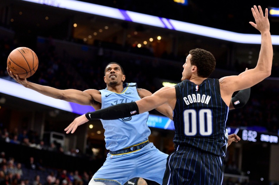 <strong>Memphis Grizzlies guard De'Anthony Melton (0)attempts a shot past the outstretched arms of Orlando Magic forward Aaron Gordon (00)&nbsp;on March 10, 2020, at FedExForum.</strong> (Brandon Dill/AP)
