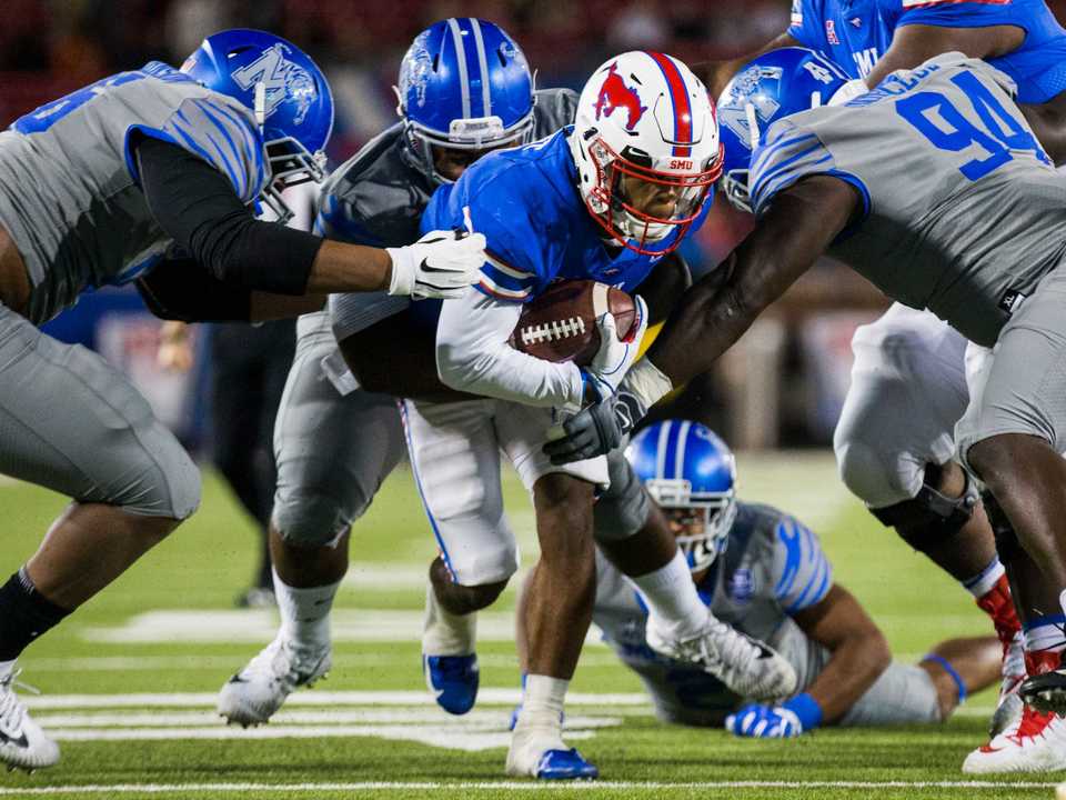 <span><strong>SMU running back Braeden West (6) is tackled by Memphis defenders during the first quarter of their matchup Friday, Nov. 16, at Ford Stadium in Dallas. Memphis won 28-18.&nbsp;</strong>(Ashley Landis/The Dallas Morning News)</span>