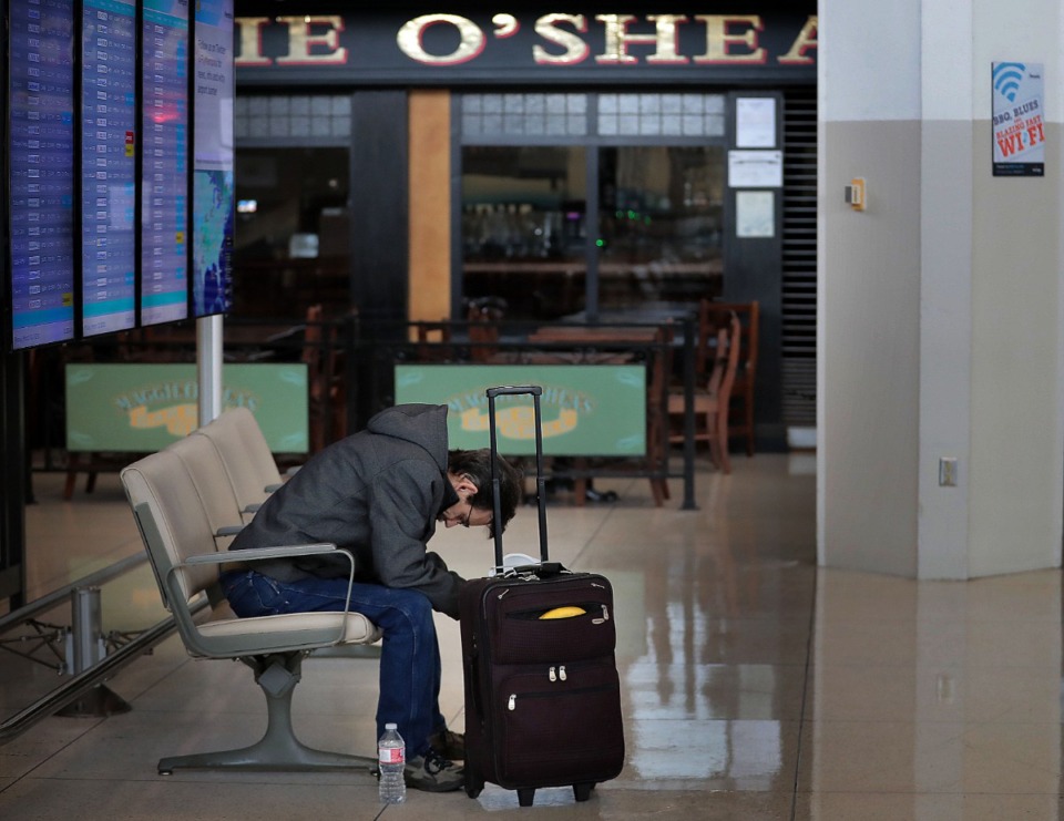 <strong>A weary Dan Aaby waits for a flight home to Roscoe, Illinois, at Memphis International Airport on March, 13, 2020. The airport has temporarily closed the C terminal checkpoint, Maggie O&rsquo;Shea&rsquo;s (background) and Moe&rsquo;s restaurants due to COVID-19 because passenger numbers have fallen significantly below projections during an expected spring break peak time.</strong> (Jim Weber/Daily Memphian)