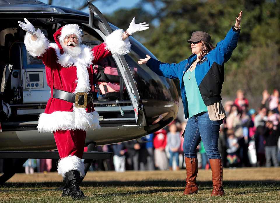 <strong>Santa, played by Charles Bohannon, greets the crowd as he arrives by helicopter at the Pink Palace Museum on Saturday, Nov. 17, to officially open the Enchanted Forest Festival of Trees, a fundraiser for Le Bonheur Children&rsquo;s Hospital.</strong> (Jim Weber/Daily Memphian)