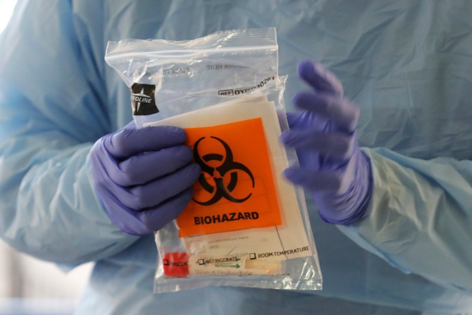 <strong>A nurse holds a sample taken for COVID-19 coronavirus testing in March 13, 2020, in Seattle.</strong>&nbsp; (AP Photo/Ted S. Warren)