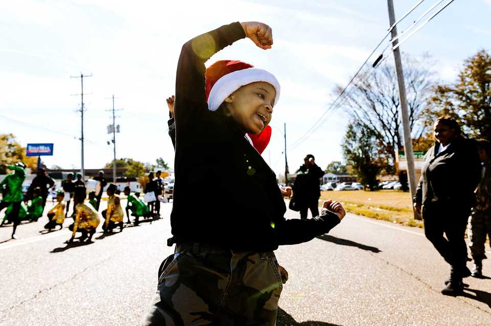 <strong>Maliyah Moss, 8, dances with students of Lucie E. Campbell Elementary during the Whitehaven Christmas Parade on Saturday, Nov. 17. The parade is in its 21st year and drew over 4,000 attendees. Just under 200 schools, nonprofits and other organizations participated in the 2018 parade, one of several outreach initiatives held by the Academy for Youth Empowerment.</strong> (Houston Cofield/Daily Memphian)