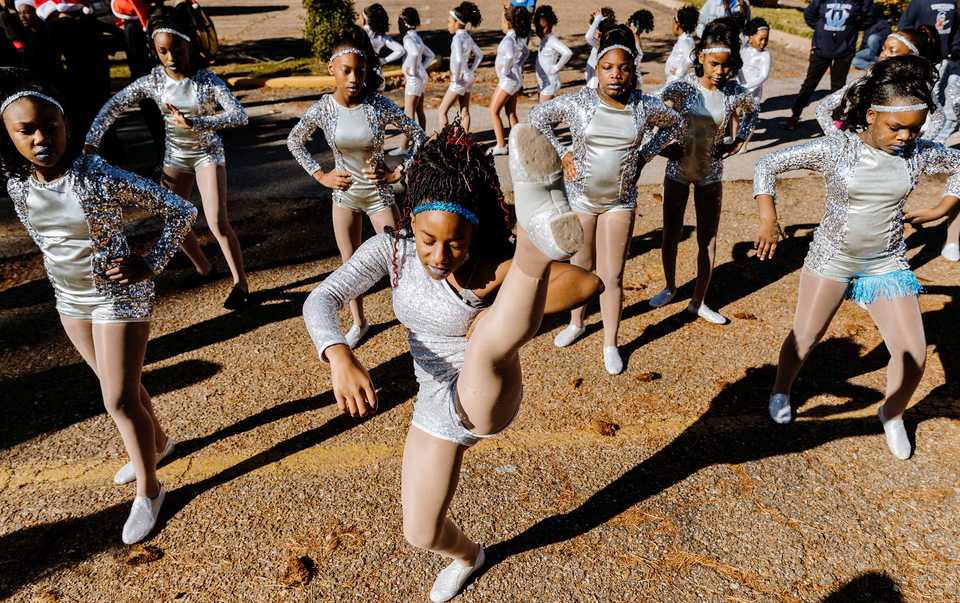 <strong>Nikiaya Harris (center) practices her dance routine with the Westhaven Elementary dance team prior to joining the Whitehaven Christmas Parade on Saturday, Nov. 17. The parade is in its 21st year and drew over 4,000 attendees. Just under 200 schools, nonprofits and other organizations participated in the 2018 parade, one of several outreach initiatives held by the Academy for Youth Empowerment.</strong> (Houston Cofield/Daily Memphian)