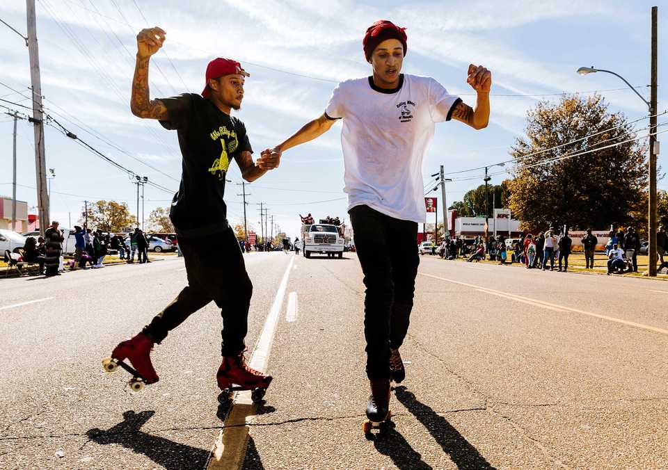 <strong>Kevin Wooten (left) and Kelon Pilate, members of Rolling Wheels of Memphis, skate down Elvis Presley Boulevard during the Whitehaven Christmas Parade on Saturday, Nov. 17. The parade is in its 21st year and drew over 4,000 attendees. Just under 200 schools, nonprofits and other organizations participated in the 2018 parade, one of several outreach initiatives held by the Academy for Youth Empowerment.</strong> (Houston Cofield/Daily Memphian)