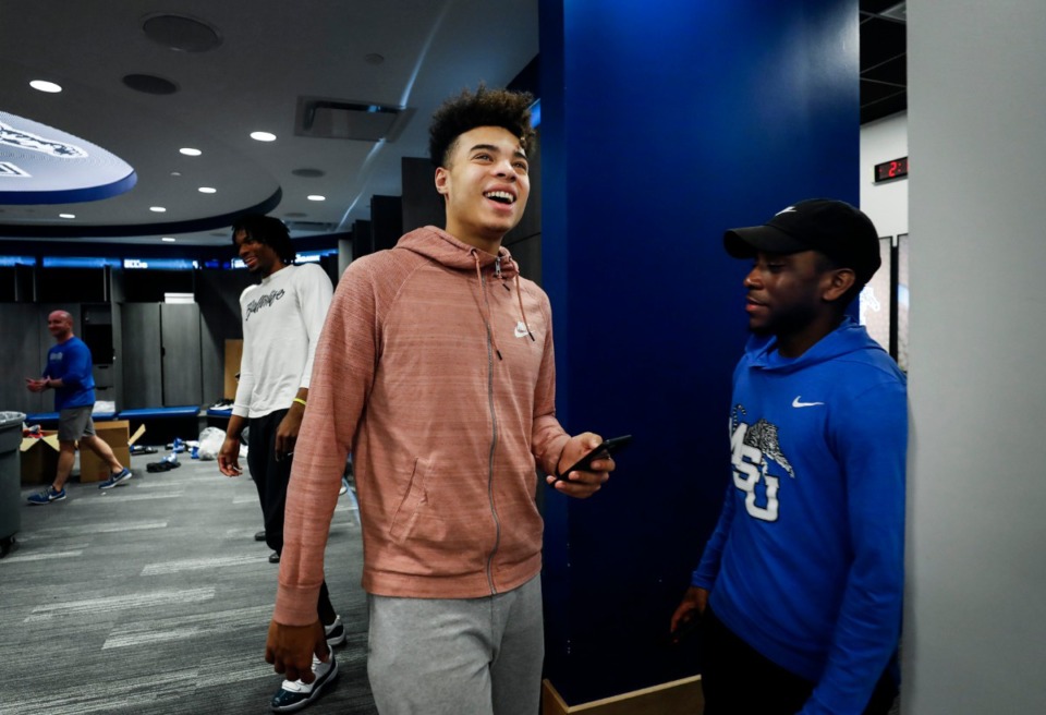 <strong>Tigers freshman guard Lester Quinones (middle) jokes with teammates and staff while leaving the team locker room on Friday, March 13, 2020, at the Laurie-Walton Family Practice Center. The party was over.</strong> (Mark Weber/Daily Memphian)