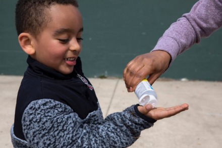 <strong>Nathan Aragaw, 4, receives some hand sanitizer, Monday, March 16, 2020, from his mother after playing soccer at a public park in northwest Washington.</strong>&nbsp;(Jacquelyn Martin/AP)